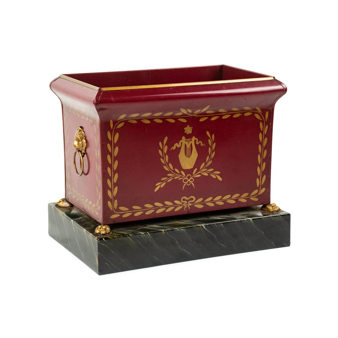 Italian Tole Jardiniere Planter with Marble Base: A vintage Italian tole jardiniere planter featuring a deep red double-lined body decorated with hand-painted gold vine and harp motifs throughout the exterior, gold-tone metal lion head handles on eac