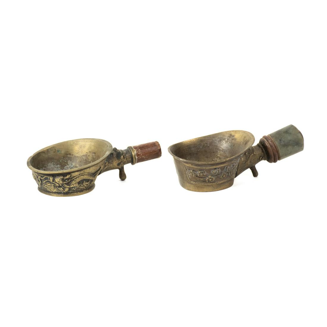 Set of 2 Chinese Brass Dragon & Floral Motif Silk Irons: Early 19th Century Qing set of 2 Chinese brass silk irons including one iron with embossed dragon motif and wooden handle and one iron with embossed floral design and spinach jade handle. Both marked 