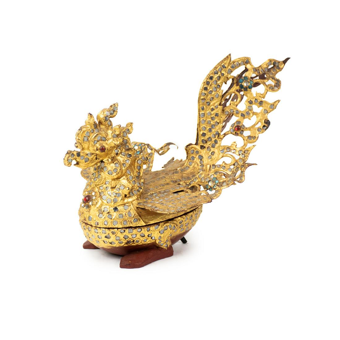 19th C Burmese Gilt Wood and Glass Hintha Betel Box: A 19th C Burmese betel box in the form of Hinta or Hintha (goose) constructed of gilt wood with inlaid clear, red, and sea green glass. The inside is painted in red lacquer.