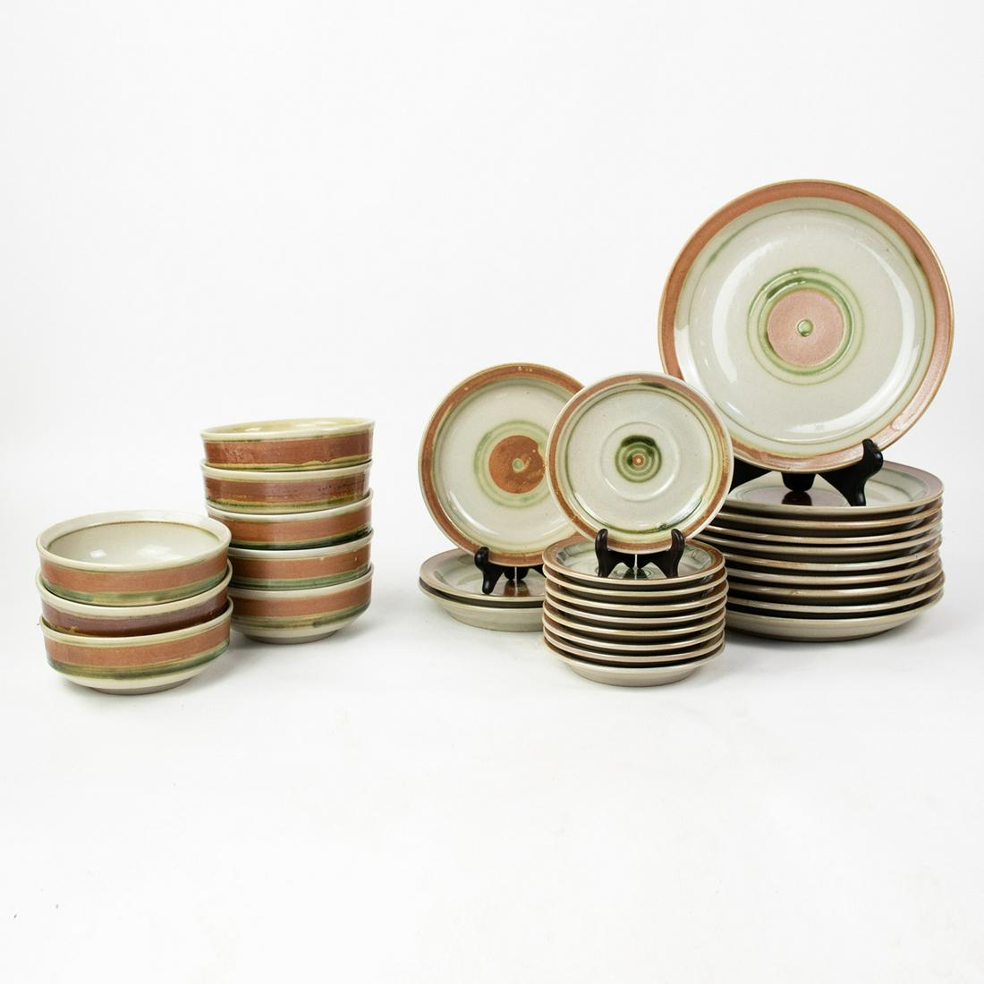 Iron Mountain Stoneware Whispering Pines Dinnerware: A 30 piece set of Iron Mountain Stoneware in Whispering Pines pattern dinnerware including 10 dinner plates, 3 salad plates, 9 saucers, and 8 cereal bowls. Marked on underside.