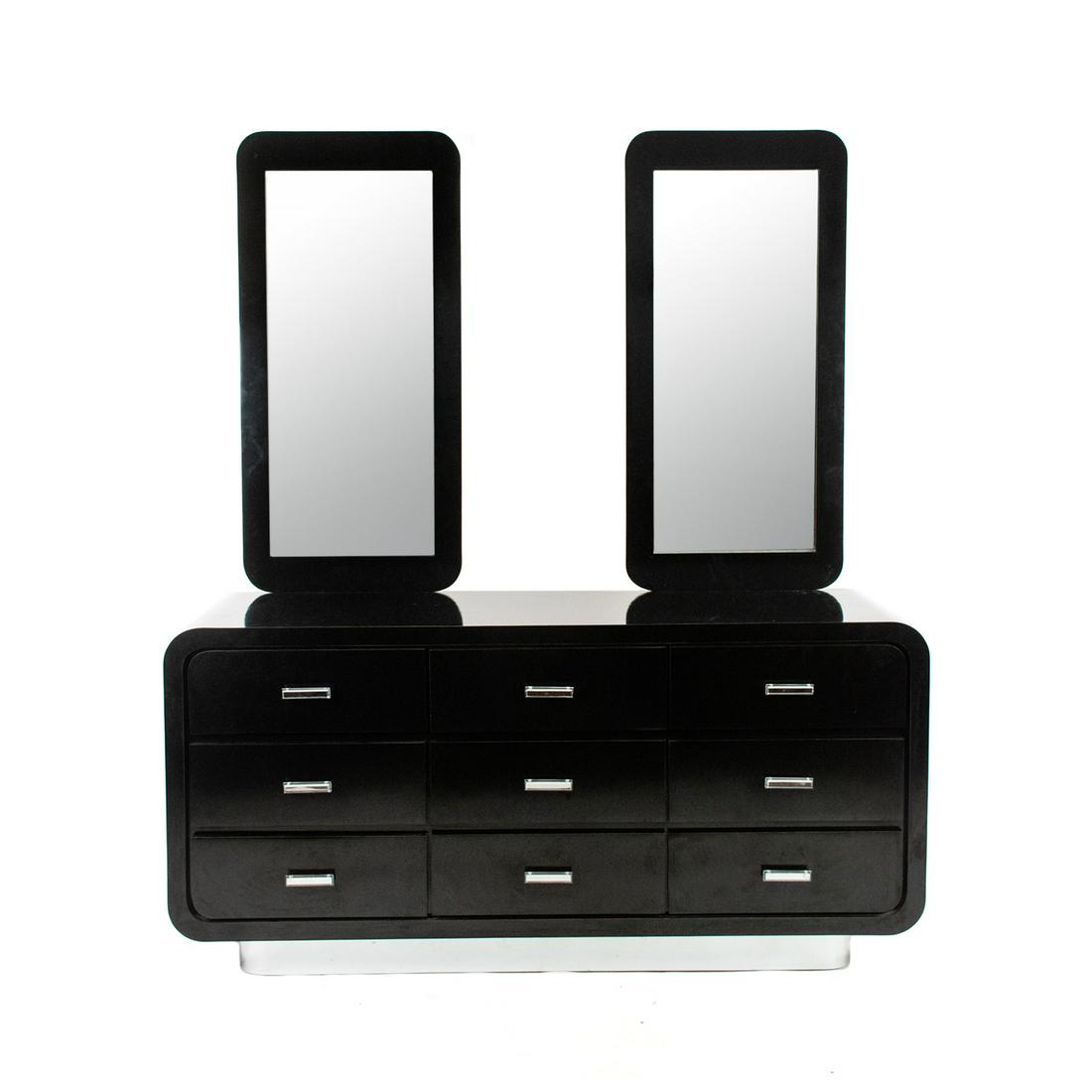 Modern Long Dresser After Karl Springer: An early 80's Memphis Group style Postmodernist nine drawer dresser having Art Deco Waterfall style shape black acrylic veneer over wood on polished chrome steel base; two vertical mirrors attached at