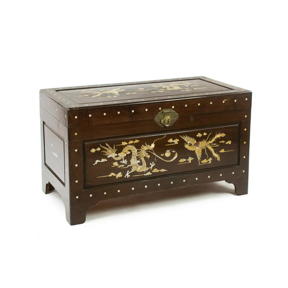 Chinese Mother of Pearl Inlaid Dragon Camphor Chest: A Chinese Mother of Pearl inlay dragon motif camphor chest having yellow MOP dragon and bird scene with clouds and repeated dot pattern throughout. Features brass hardware with an ornate brass lock pl