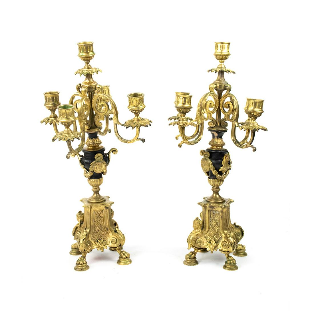 Italian Baroque Gilt Bronze Ormolu Candelabras - a Pair: A pair of Italian Baroque five light gilt bronze ormolu candelabras having four lower candle holders and one at the top, all adorned with bronze leaf and filigree details. They feature wooden urn shap