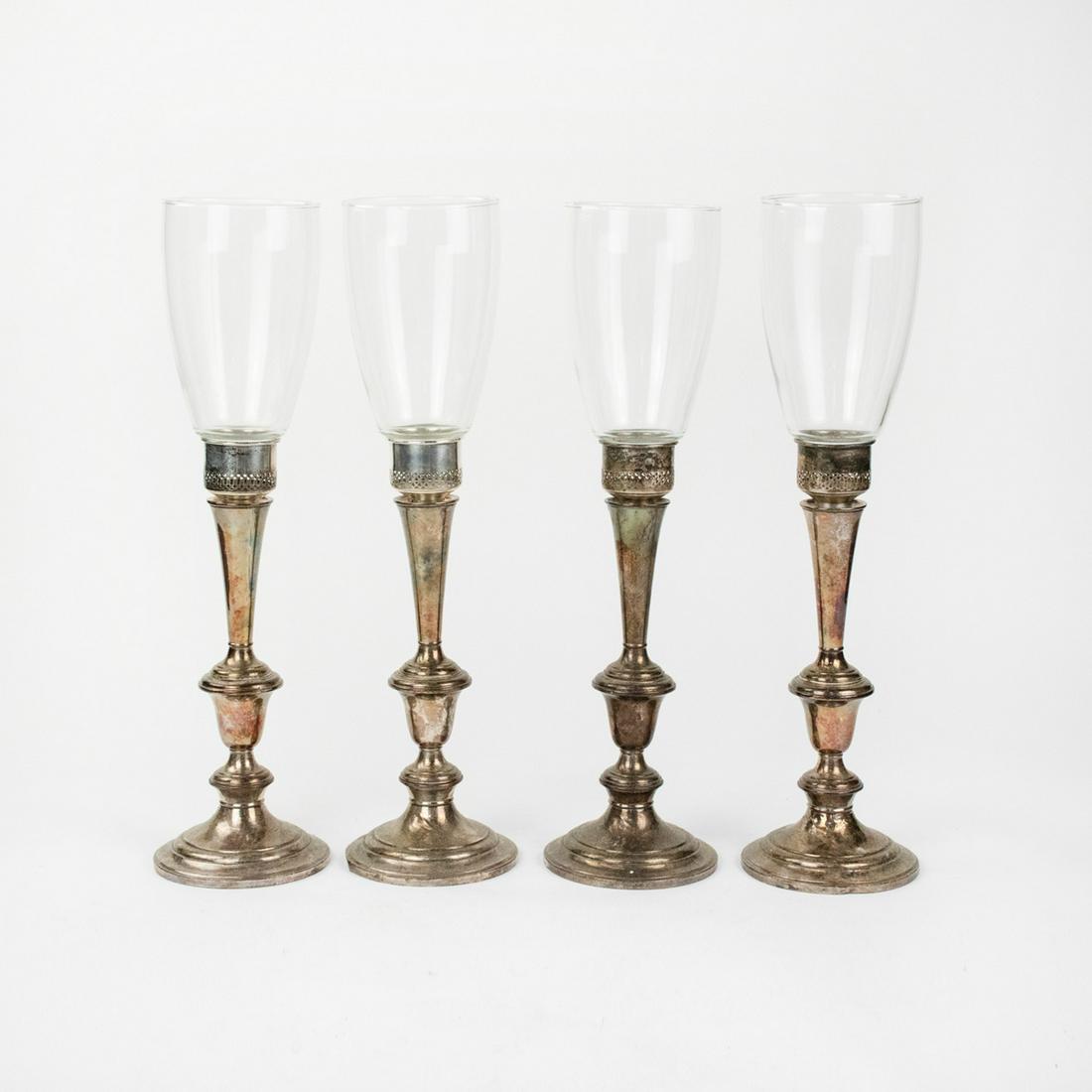 Set of Gorham Weighted Sterling Hurricane Lamps: A set of four vintage weighted sterling silver and glass hurricane lamps by Gorham, each featuring a sectioned form and pierced capital. Each is marked "Gorham Sterling Cement Filled Reinforced with R