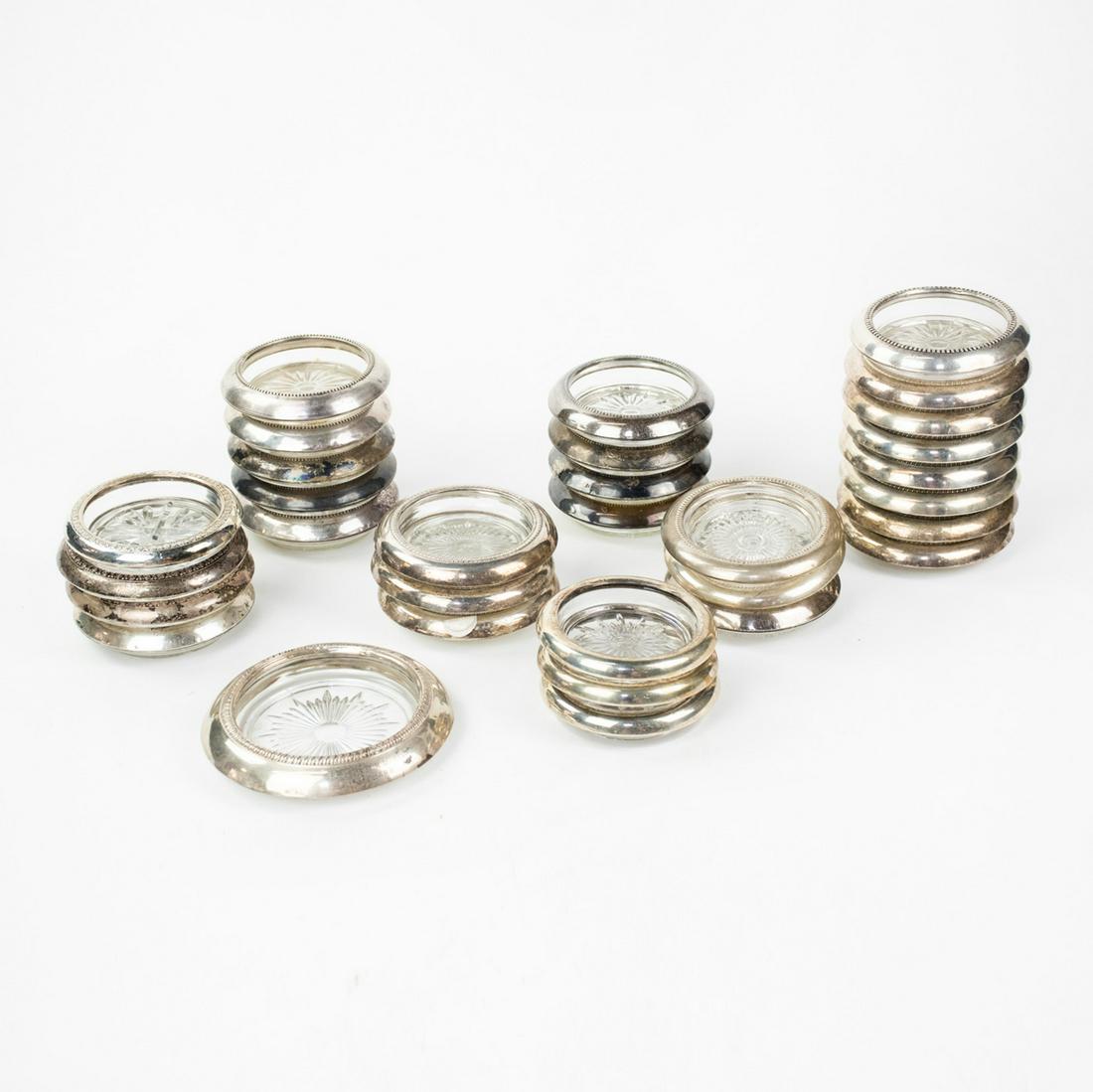 Collection of Sterling Rimmed Glass Coasters: A collection of 31 vintage sterling silver rimmed glass coasters. Most are marked "Sterling".
