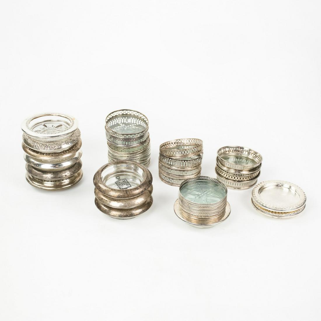 Collection of Sterling Rimmed Glass Coasters: A collection of 34 vintage sterling silver rimmed glass coasters. Most are marked "Sterling".