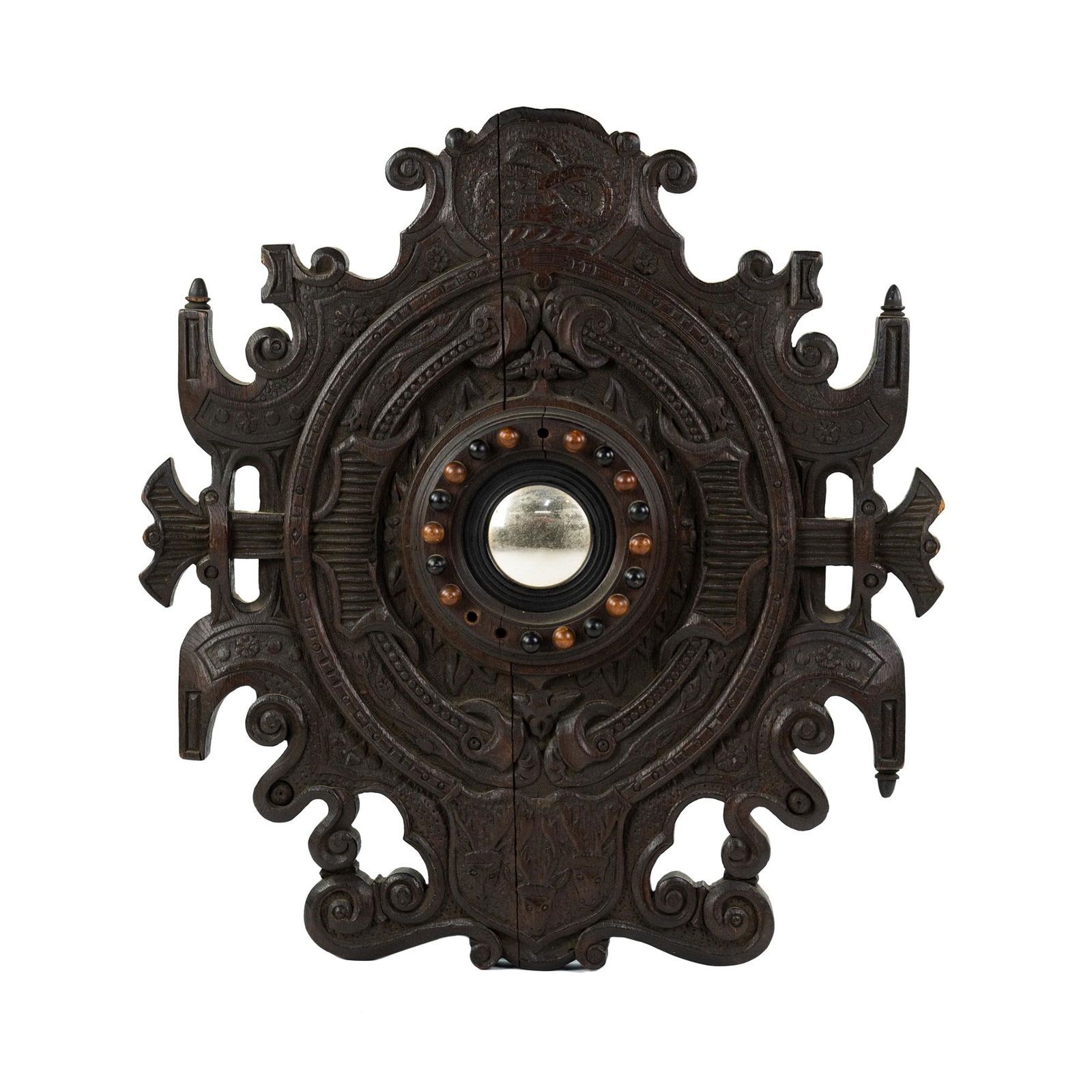 Rococo Style Heavily Carved Convex Shield Mirror: A Rococo style heavily carved convex shield form mirror having carved serpent and deer motif with small convex mirror in center and wooden ball surround in various tones of brown. Unmarked.