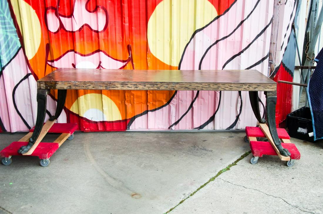 Antique Renaissance Style Iron Paw Foot & Steel Table: An antique Renaissance style iron claw foot and steel dining table having a steel table top with small hatched marks around the edge and apron. It rests atop four curved lion's paw foot legs. Shipping