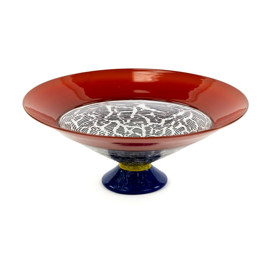 Nine Iron Studios Art Glass Pedestal Bowl: A Nine Iron Studios art glass pedestal bowl circa 1995 having red rim, crackled black bowl resting atop yellow and blue pedestal base. Etched on underside.