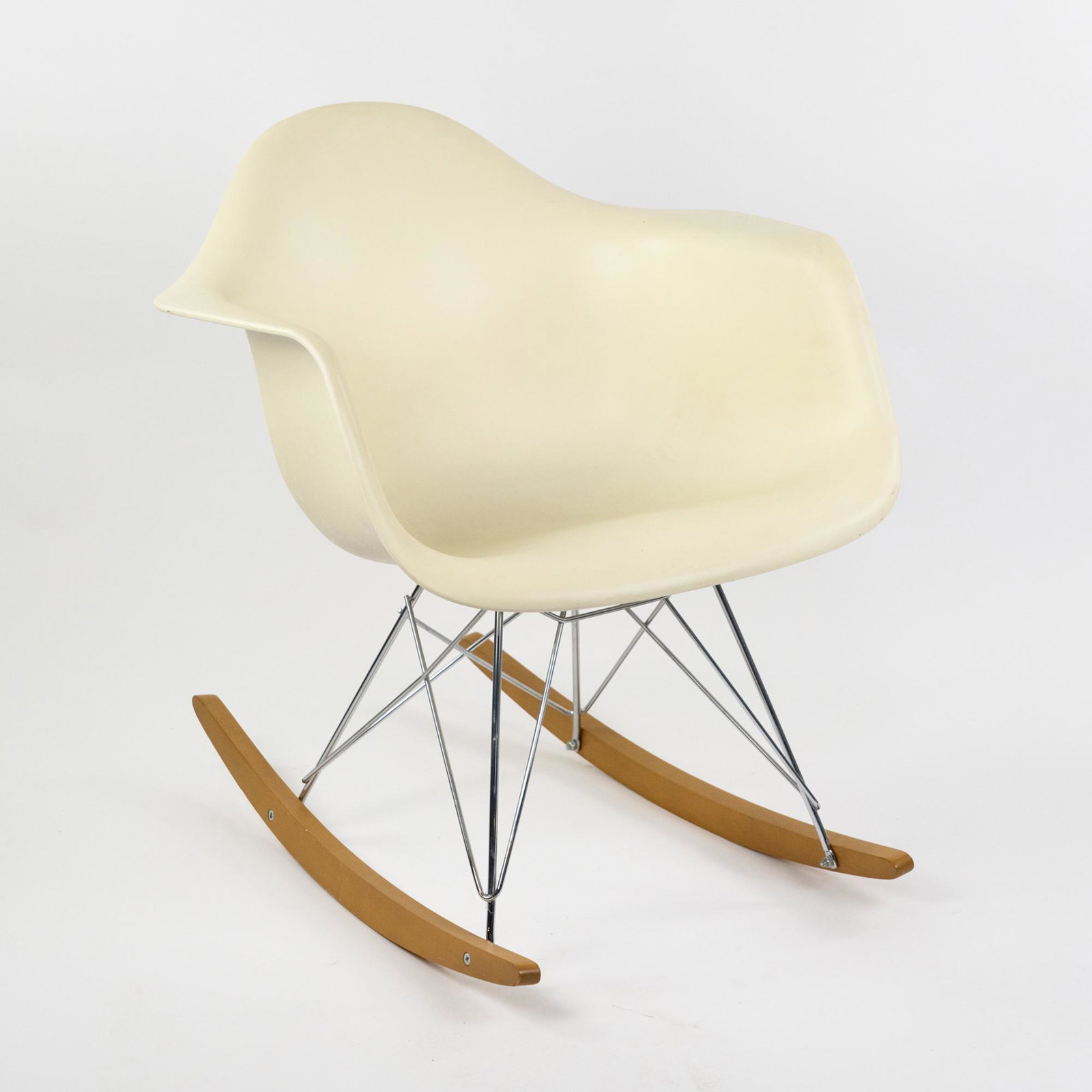 Eames for Herman Miller White Shell Eiffel Tower Rocker: A vintage Eames for Herman Miller white molded plastic shell armchair having eiffel tower metal base with wooden runners. Marked on underside. Seat height: 15" Shipping Atlanta Auction Gallery will no