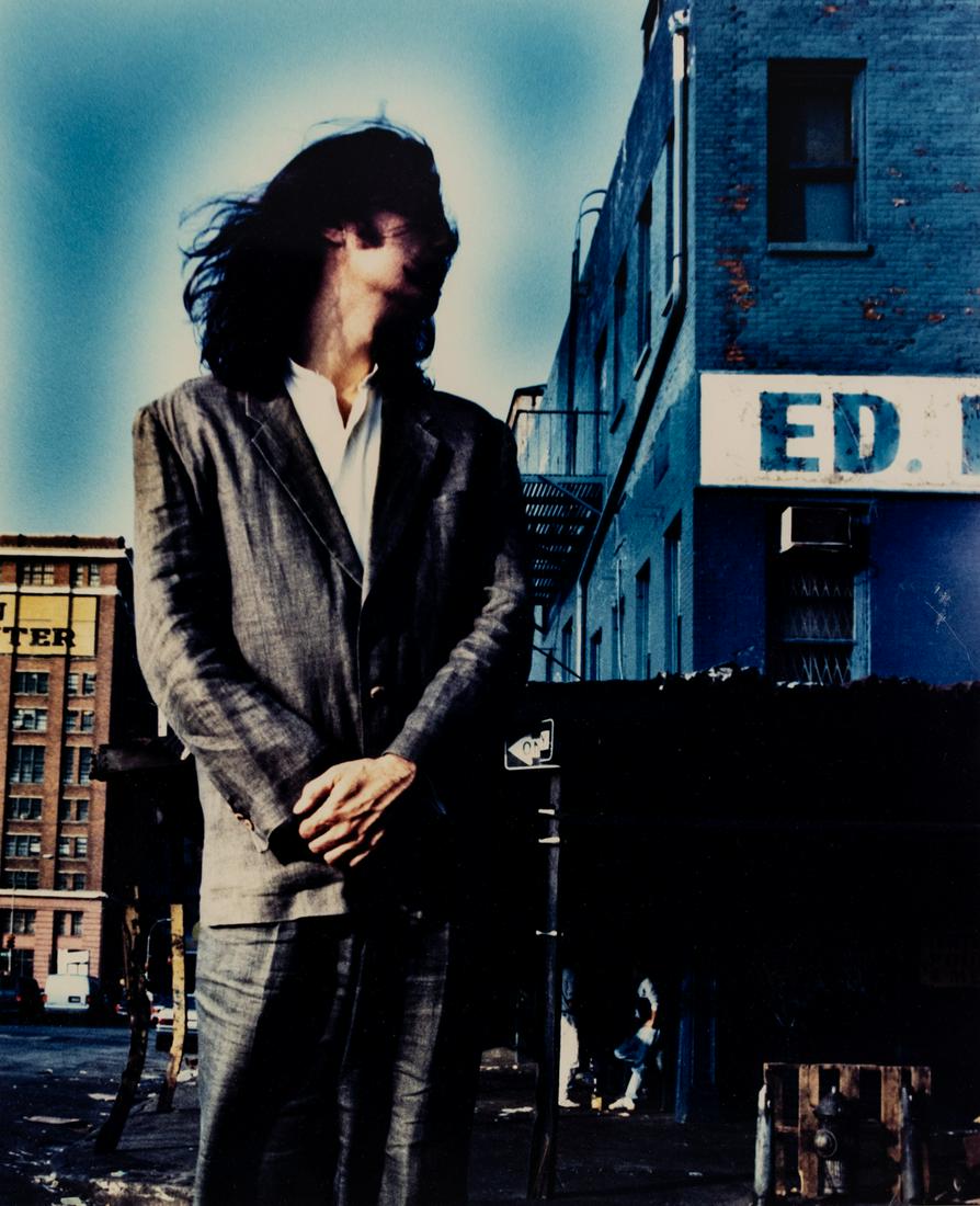 Jayne Wexler 'David Byrne' Color Photograph: A vintage Jayne Wexler (American) colored photograph titled 'David Byrne' depicting the man in a suit with long hair. Presented in wood frame. Signed in lower margins with photographer's information a