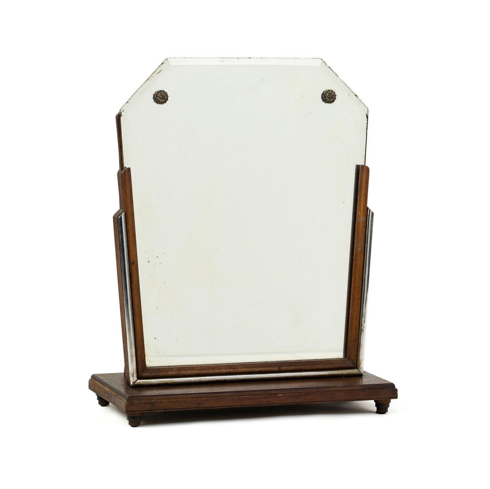 French Art Deco Dressing Table Mirror: A French Art Deco dressing table mirror having cut out wooden design and base with ornate metal hardware resting atop four small legs. Mirror is beveled. Unmarked.