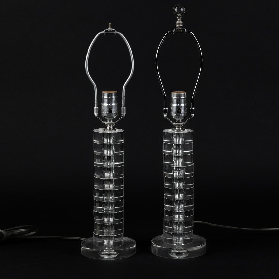 (2) Pair of Mid-Century Lucite Stacked Table Lamps: A pair of mid-century lucite stacked table lamps having cylindrical body with clear, stacked lucite discs and silver cap and stem. Unmarked. Height measured base of bulb.