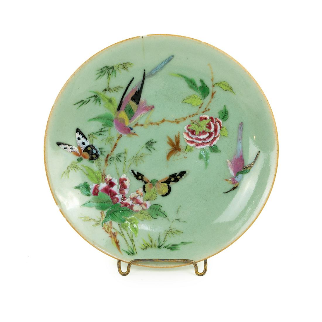 Chinese Bean Green Glazed Bird and Flower Plate: An antique Chinese bean green glazed plate having a butterfly, bird, and flower painted scene motif. Marked on underside.