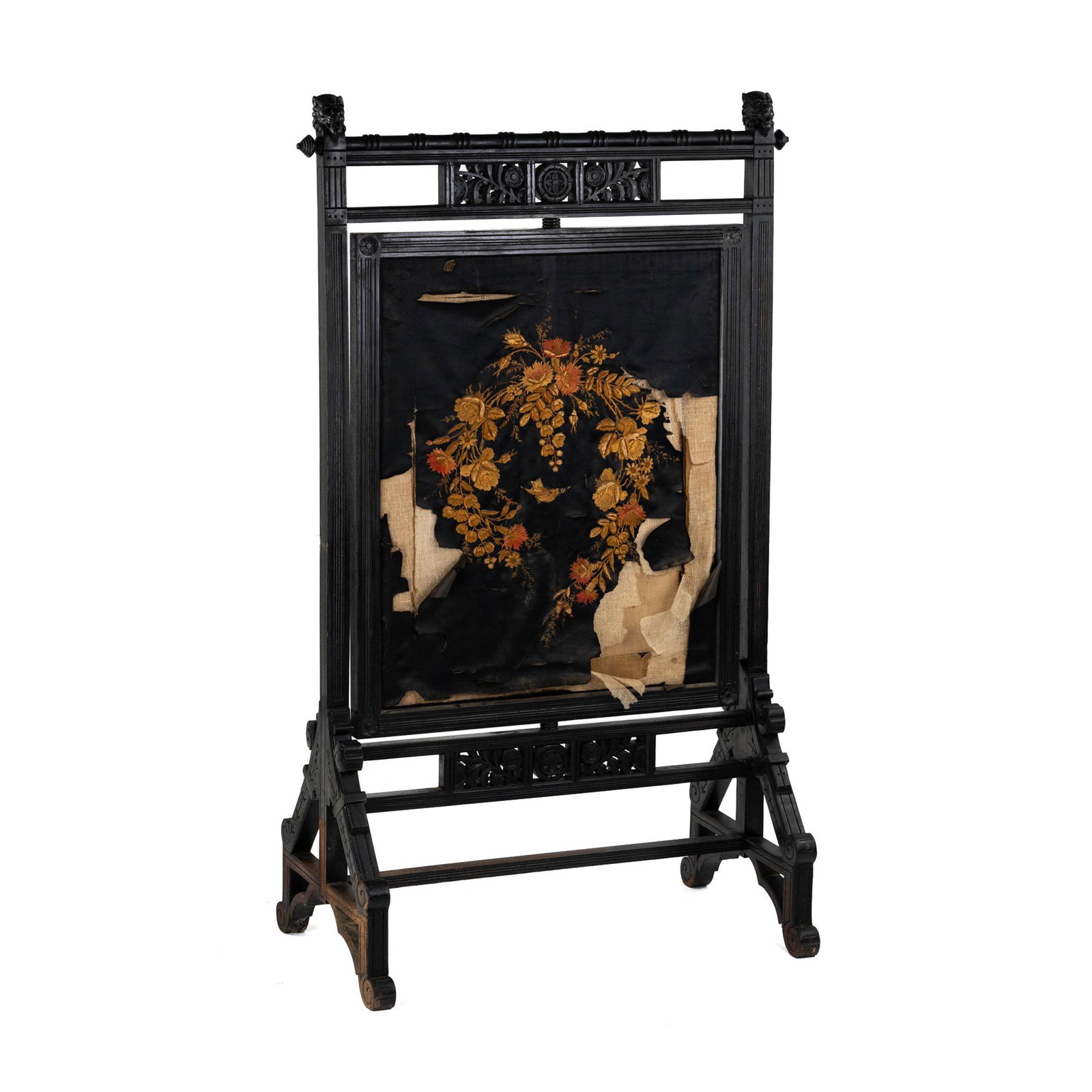 Victorian Aesthetic Movement Upholstered Fire Screen: A Victorian Aesthetic Movement fire screen having black floral embroidered upholstery with ebonized wood carved base and floral medallion accents. Unmarked. SHIPPING Atlanta Auction Gallery will not s