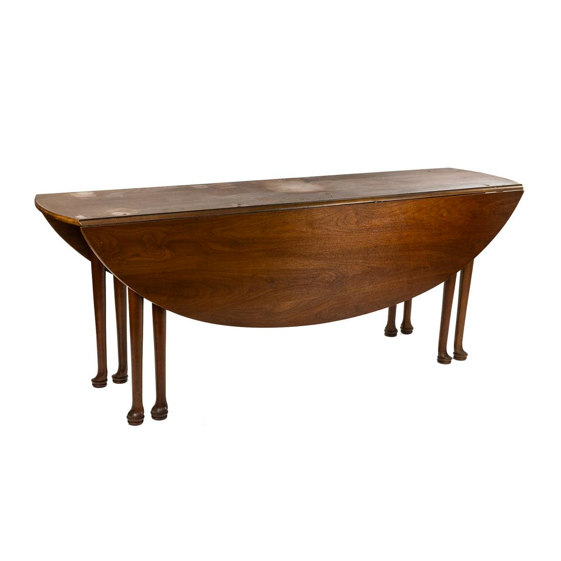 Georgian Style Mahogany Drop Leaf Oval Dining Table: A Georgian style mahogany wood oval form drop leaf dining table having two rounded drop leafs and gate legs. SHIPPING Atlanta Auction Gallery will not ship this lot in house. The buyer is responsible
