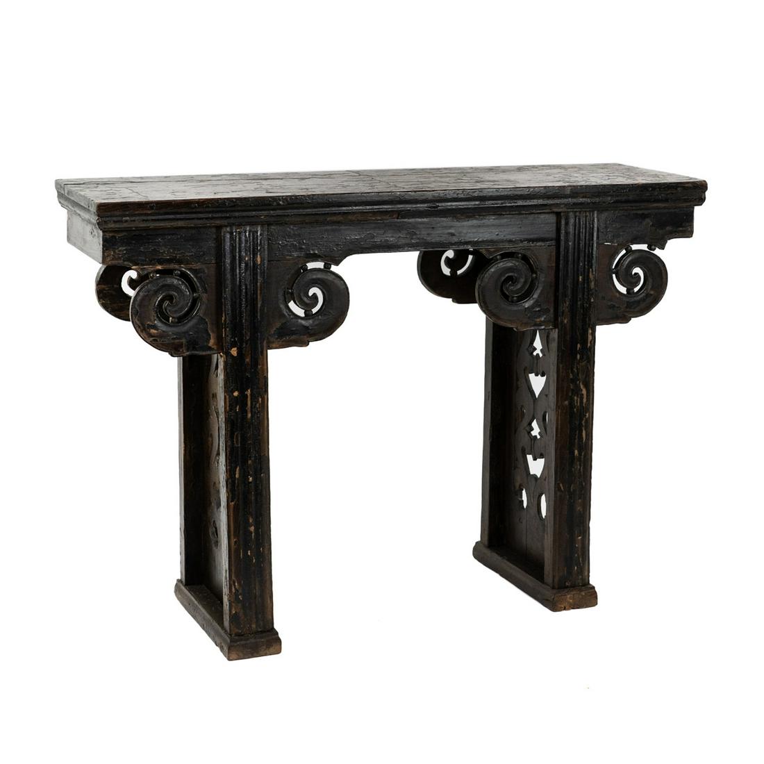 Late Qing Chinese Carved Altar Console Table: A late Qing dynasty Chinese altar table having flat board top with decorative Ruyi scrolls on both sides, reticulated carved column legs on either side featuring a cutout design. Unmarked. SHIPPING At