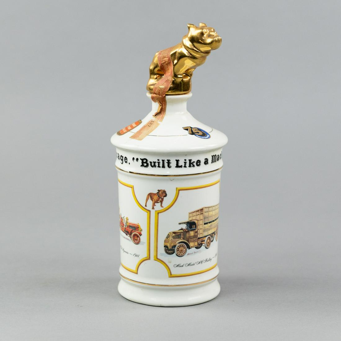 1975 First Issue Wild Turkey Mack Truck Decanter: A 1975 first issue limited edition 75th anniversary commemorative Wild Turkey Mack Truck decanter - 'Built Like a Mack Truck - It's Part of The Language' decorated with various Mack truck models and h