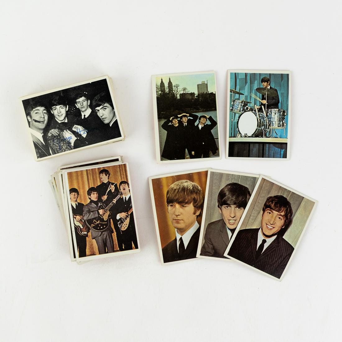 (56) 1964 Topps Beatles 2nd Series & Color Cards: A group of 56 Topps 1964 Beatles trading cards including 35 2nd series black and white photo cards and 21 Beatles Color Cards.