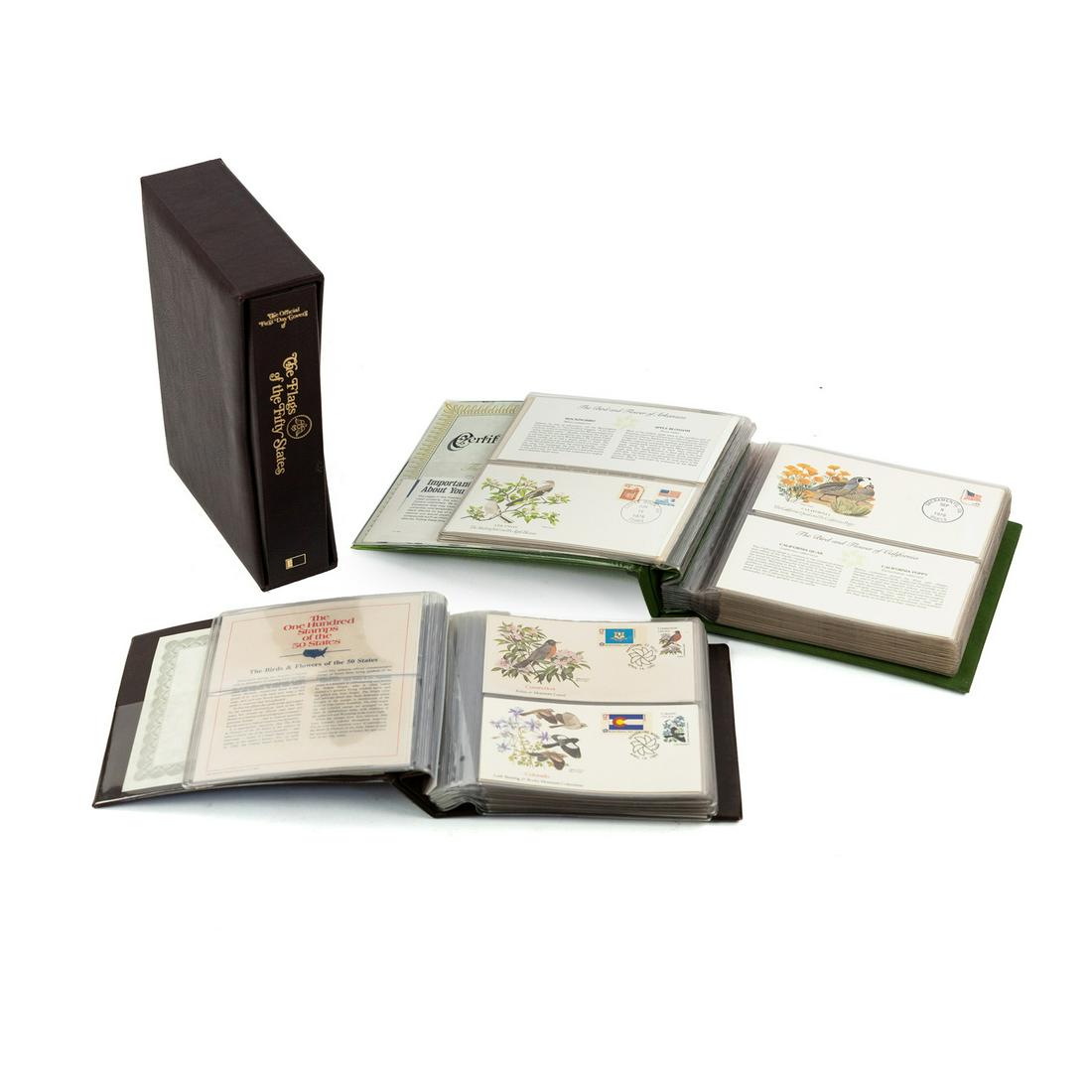 (3) US State Stamp Cover Albums Flags, Birds & Flowers: A group of 3 stamp cover albums including 'The Flags of the Fifty States' 1976 album containing 50 First Day covers, 'The Birds and Flowers of the 50 States' containing a limited edition commemorative