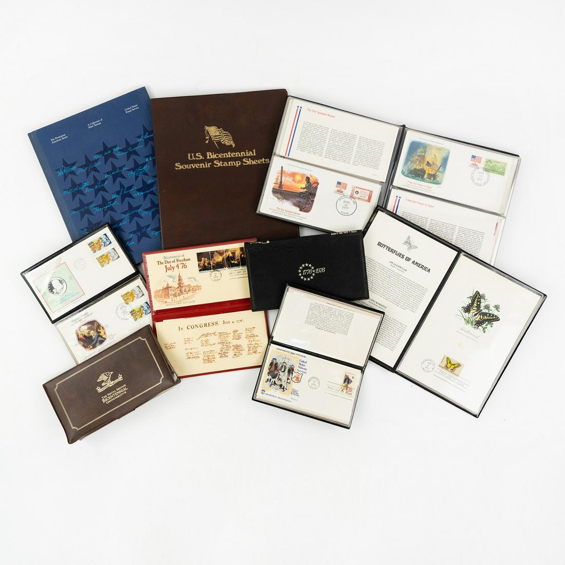 US Stamp Cover Albums First Day, Souvenir Sheets: A collection of US stamp cover and First Day of Issue stamp cover albums, souvenir sheets, etc. including a 'Spirit of 76' commemorative US military First Day of Issue cover album containing 5 stamp c