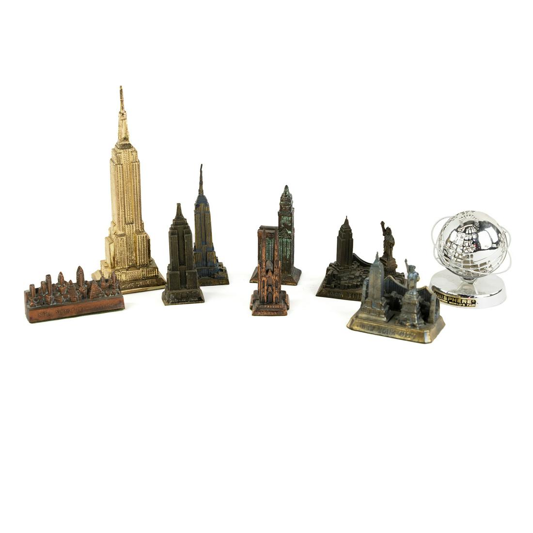 (9) NYC Souvenir Miniature Building Monument Replicas: A group of 9 New York City themed collectible souvenir miniature metal and plastic replicas of buildings and monuments including St. Patrick's Cathedral, Empire State Building, the New York skyline, W