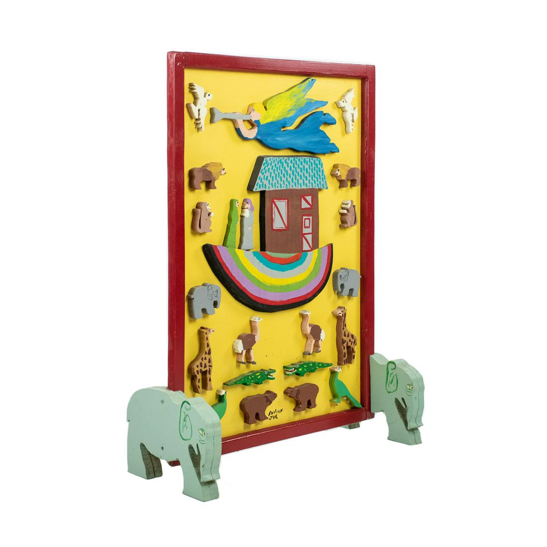 Indian Joe Folk Art Noah's Ark Wooden Sculpture: Indian Joe Folk Art hand painted Noah's Ark wooden sculpture having cut out animals and figures with an ark in the center resting atop two painted elephant form feet. Signed in paint in lower center.
