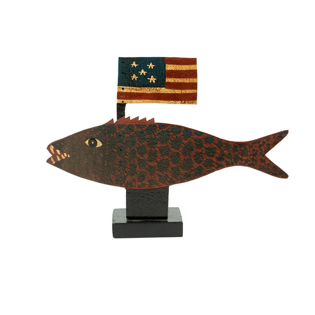 Fish with Flag Metal Folk Art Sculpture: A Diana M. folk art painted metal sculpture circa 1994 depicting a fish with a 5-star American flag protruding from its back, after an 1850 sculpture titled 'Fish with Flag Sign' featured in the Shelb