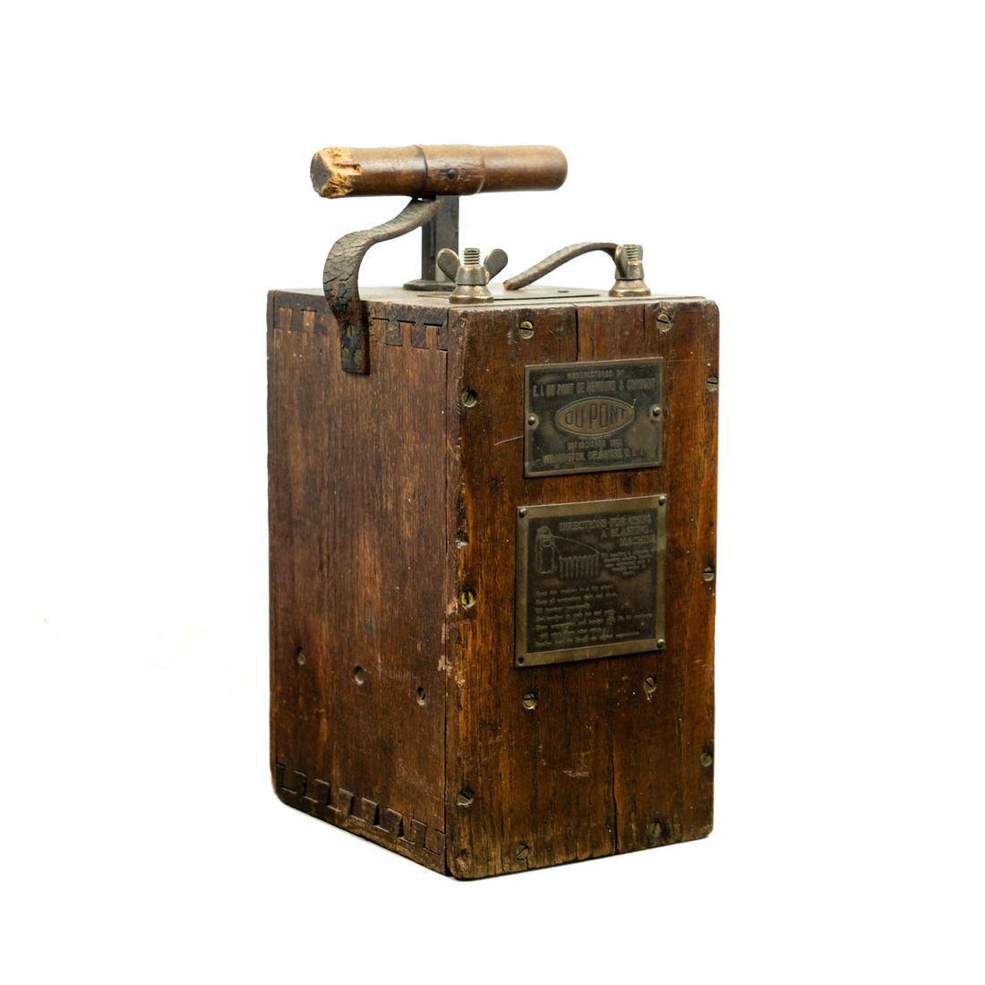 Dupont Blasting Machine Detonator No 30: A Du Pont early 20th century Blasting Machine model number 30 having a dovetailed walnut case, iron plunger with turned wood grip, and a leather carrying handle. Has embossed brass labels - 'Dupont Bl
