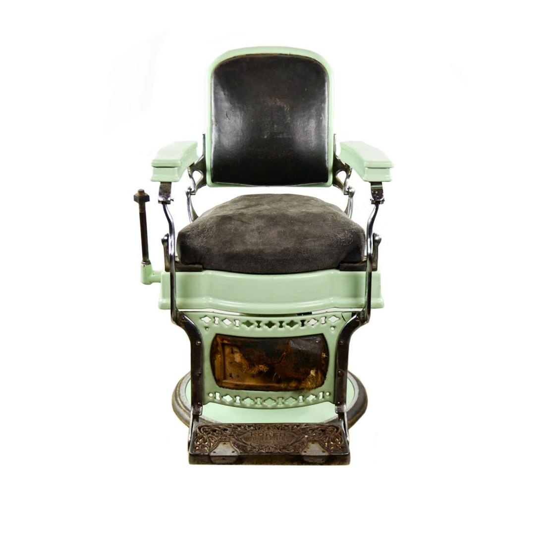 Koken Porcelain Enamel Hydraulic Lever Barber Chair: A Koken porcelain enamel mint green swivel barber chair circa early 20th C with black leather upholstered backrest, suede upholstered seat, and a cast metal foot rest marked 'Koken Companies, St. Loui