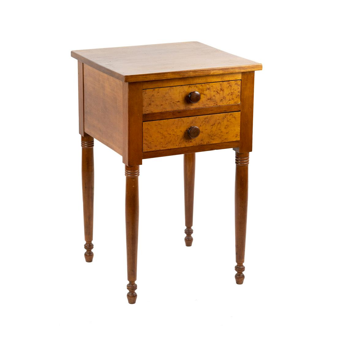 American Sheraton 2 Drawer Side Table: An American Sheraton style 2-drawer side table stand with turned wood legs having birds eye maple veneer drawers each having a single wood knob pull.