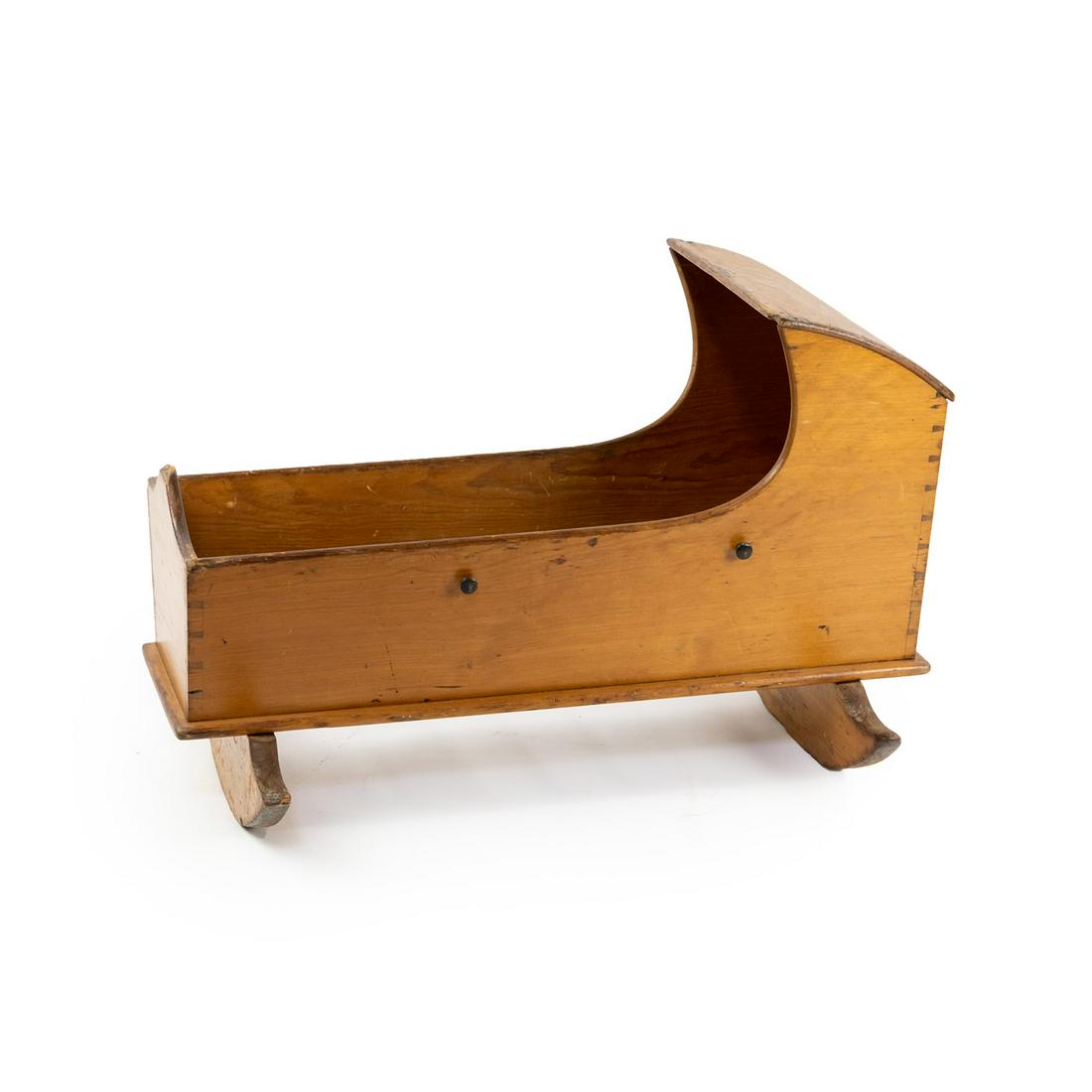 18th C American Hooded Rocking Cradle: An early American 18th century hooded cradle on 2 rockers having dovetailed construction and 2 pull knobs on each side.