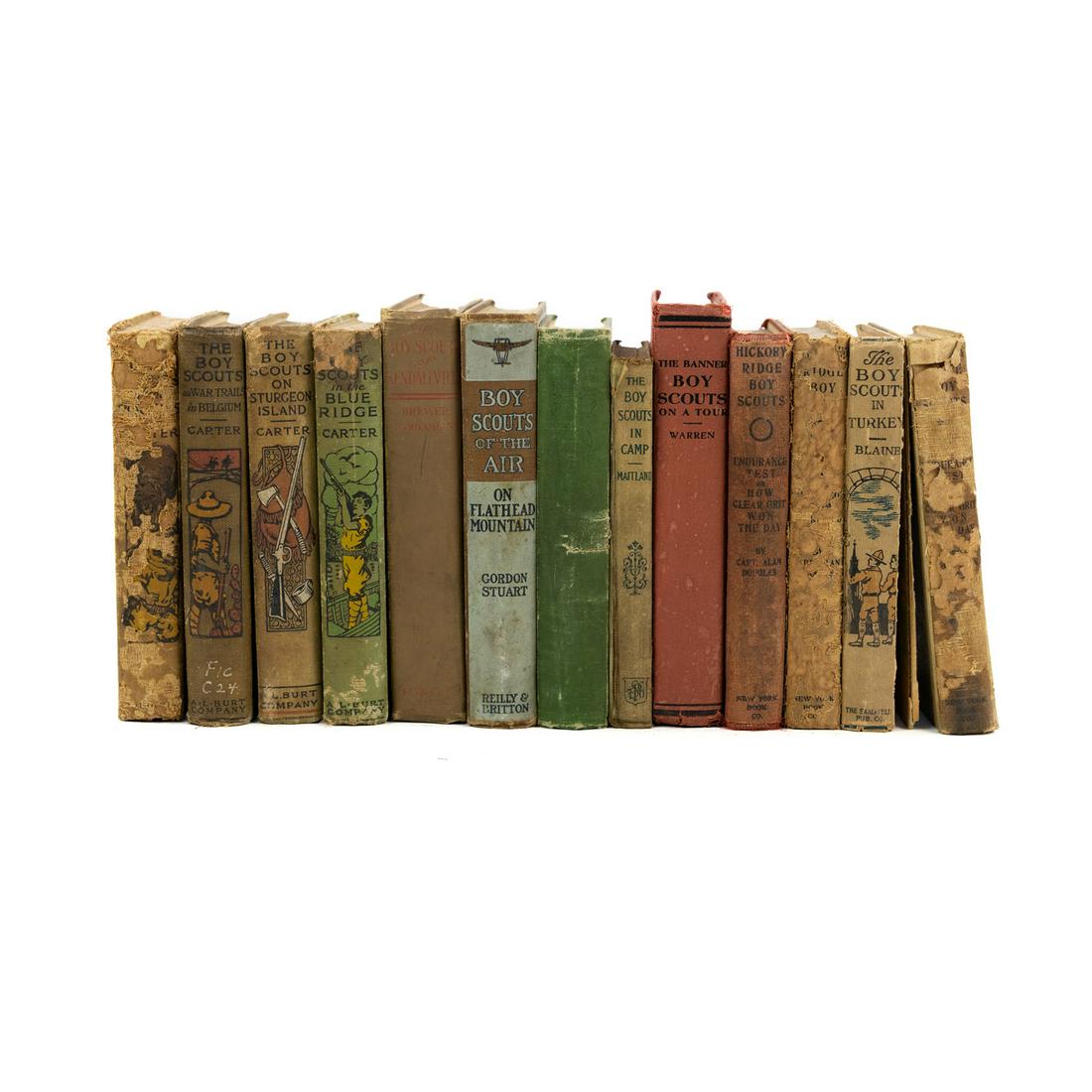 (13) Vintage Boy Scout Fiction Hardcover Books: A group of 13 vintage Boy Scout fiction hardcover books including Herbert Carter's 'The Boy Scout' series - 'The Boy Scouts In The Rockies', 'The Boy Scouts On War Trails in Belgium', 'The Boy Scouts 