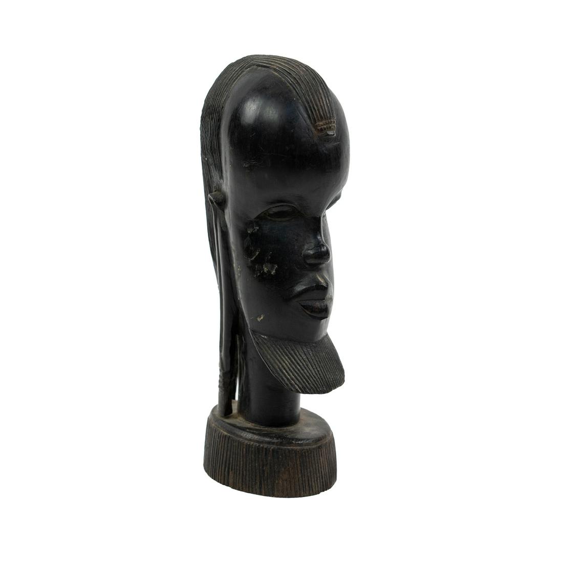 African Hand Carved Signed Ebonized Wood Bust: An African hand carved ebony wood bust with an illegibly carved signature on the underside.