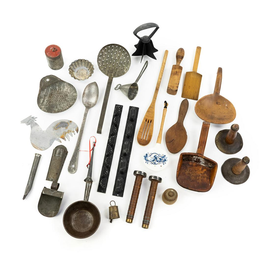 Assorted Antique Primitive Kitchen Tools and Untensils: An assortment of antique primitive kitchen tools including utensils, candy molds, cheese graters, a 6-blade chopper, an apple corer, etc.