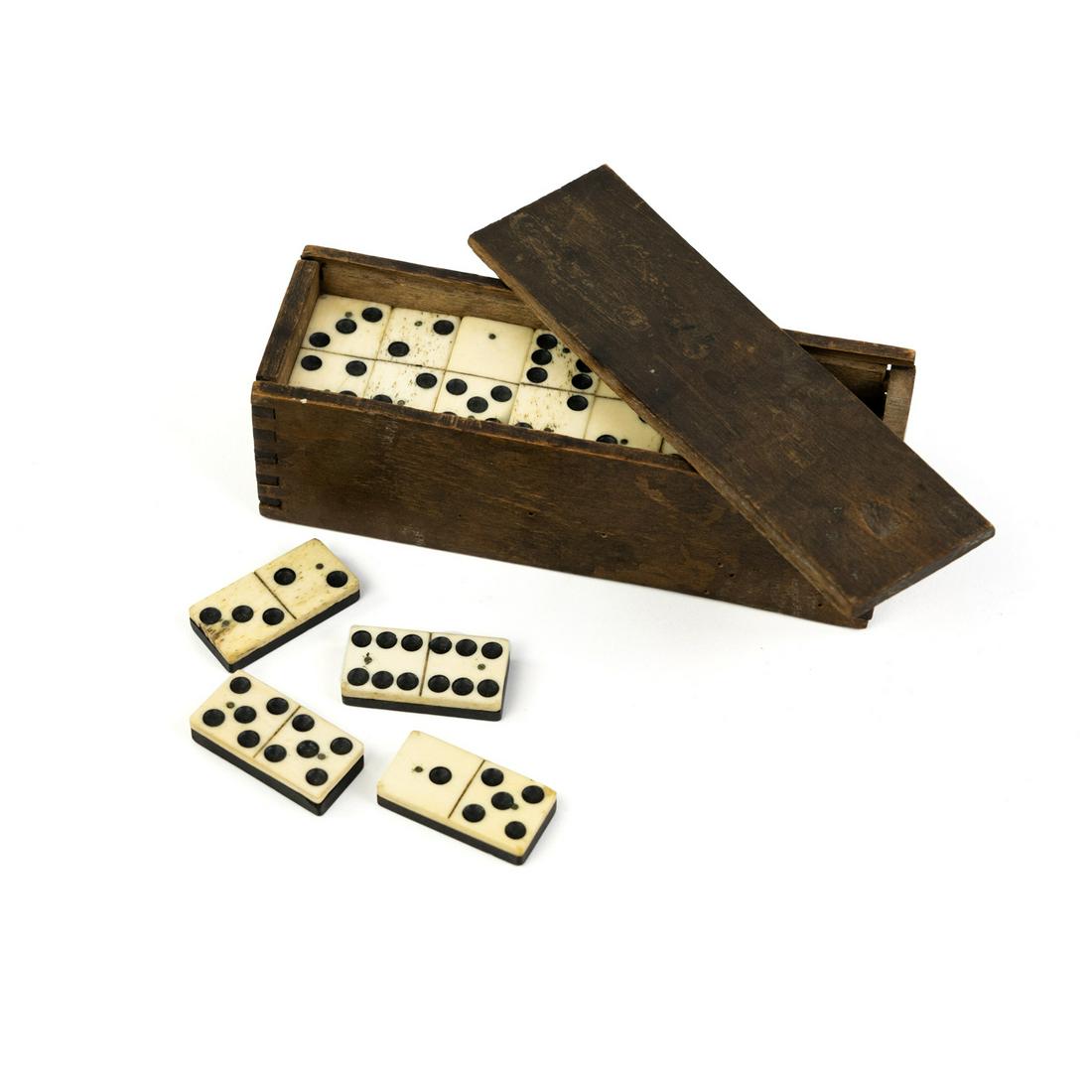 19 C Set of 28 Ebony and Bone Ivory Dominos w/Box: A set of 28 carved ebony and bone dominos having a wooden storage box with sliding top.