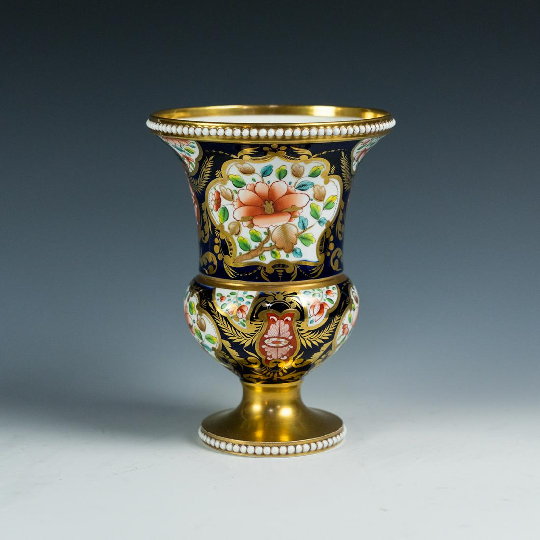 Spode Imari Pattern 1216 Spill Vase: A Spode Imari spill vase in pattern no. 1216 having cobalt blue and gold colors with floral designs and white pearl rim and pedestal base. Marked with SPODE and pattern number handwritten in red with 