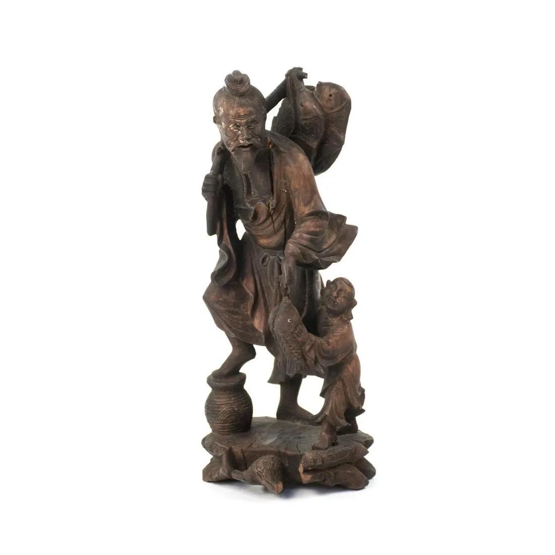 Chinese Carved Wood Fisherman and Child Figure: A Chinese carved wood fisherman and child figure sculpture depicting an old man holding a fishing pole with a small child at his side.