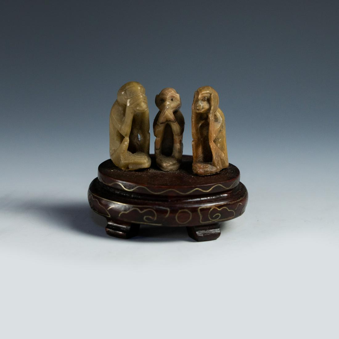(3) Chinese 'Three Wise Monkeys' Hardstone Netsuke Figures: A set of three (3) Chinese carved hardstone 'Three Wise Monkeys' netsuke figures with a carved wooden base. Unmarked.