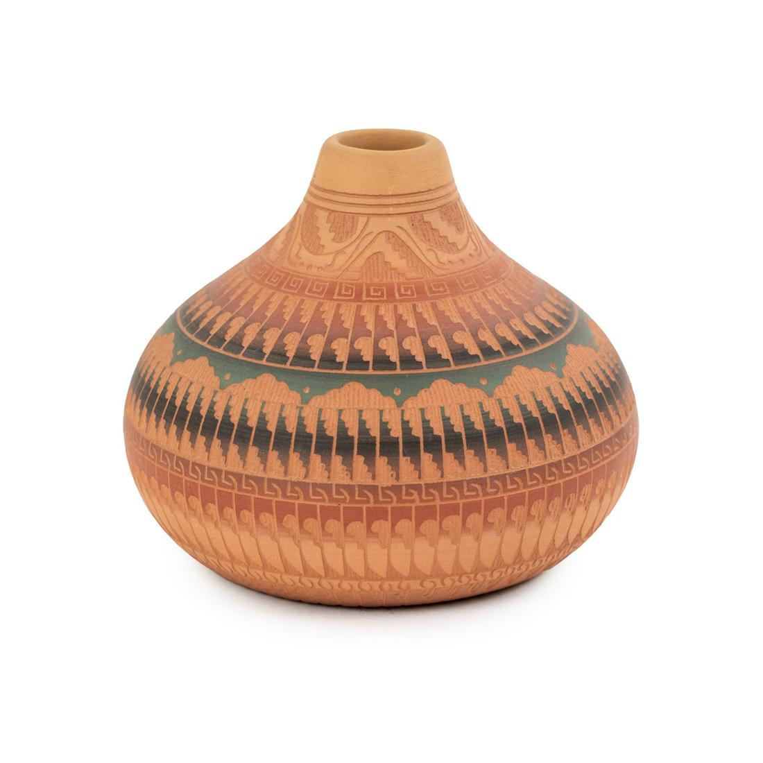 M. Tom Navajo Hand-Etched Vase Signed: An M. Thomas Navajo carved and painted red clay vase having blue, purple and green tone painted geometric design with tapered neck. Incise signed 'M. Tom 93 Navajo' on the underside.