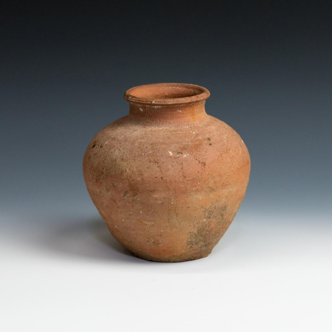 Early Terracotta Clay Storage Shipping Jar: An early terracotta clay storage shipping jar origin unknown, possibly from China, having rounded body with flared opening and signs of barnacles or other crustaceans ounces attached to the bottom. Fr