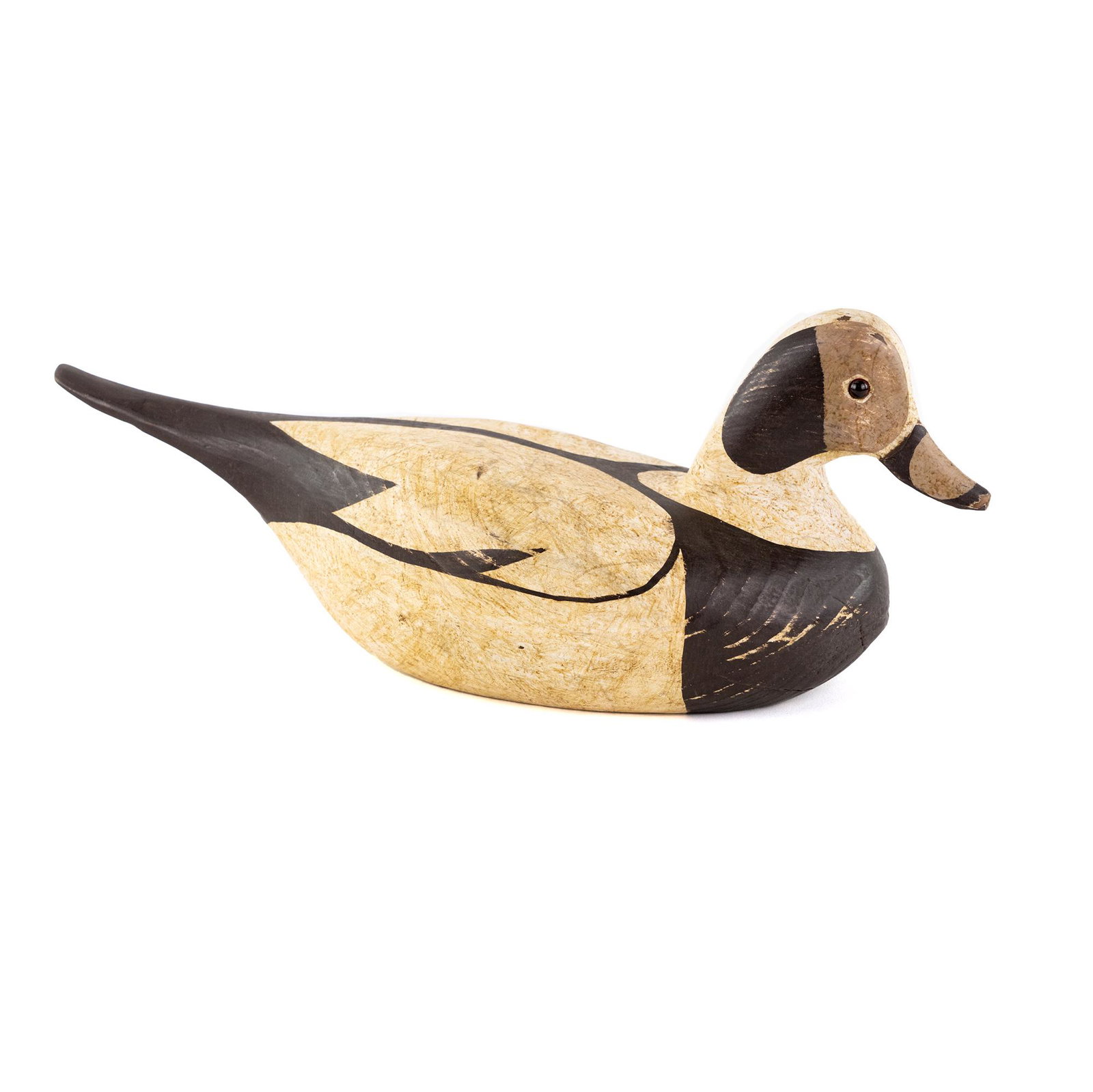 Hand Carved Old Squall Duck Decoy: An Old Squall (Squaw) hand carved wood duck decoy hand painted in white and brown having glass eyes.