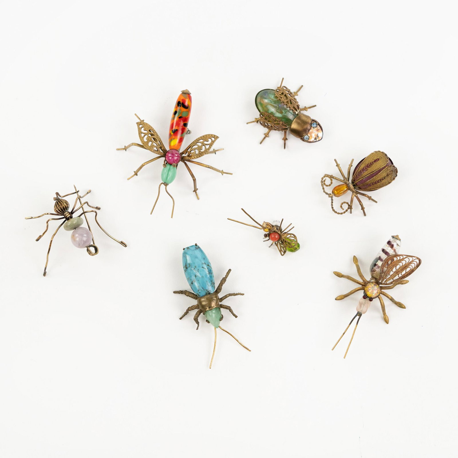 (7) Grouping of Bejeweled Insect Brooches: A grouping of seven (7) jeweled brooches depicting insects with gold colored bodies including; beetles, mosquitos, and flies. Measurements are for longest.