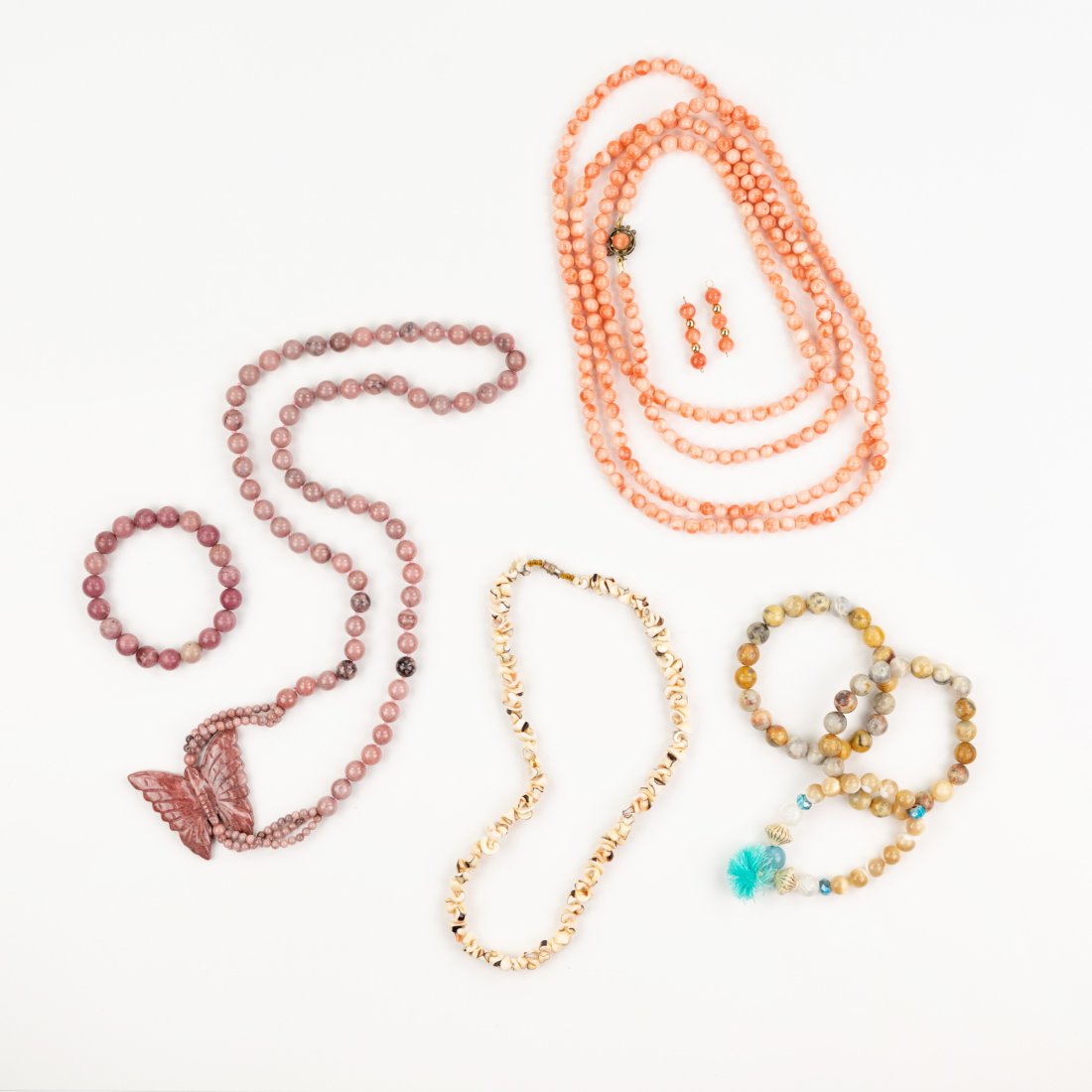 (8) Group of Japanese Momo Coral and other Jewelry: A group of eight (8) pieces of jewelry including Rhodochrosite butterfly charm necklace and matching bracelet, Japanese Momo coral necklaces and pair of earrings, three Mexican Crazy Lace agate bracel