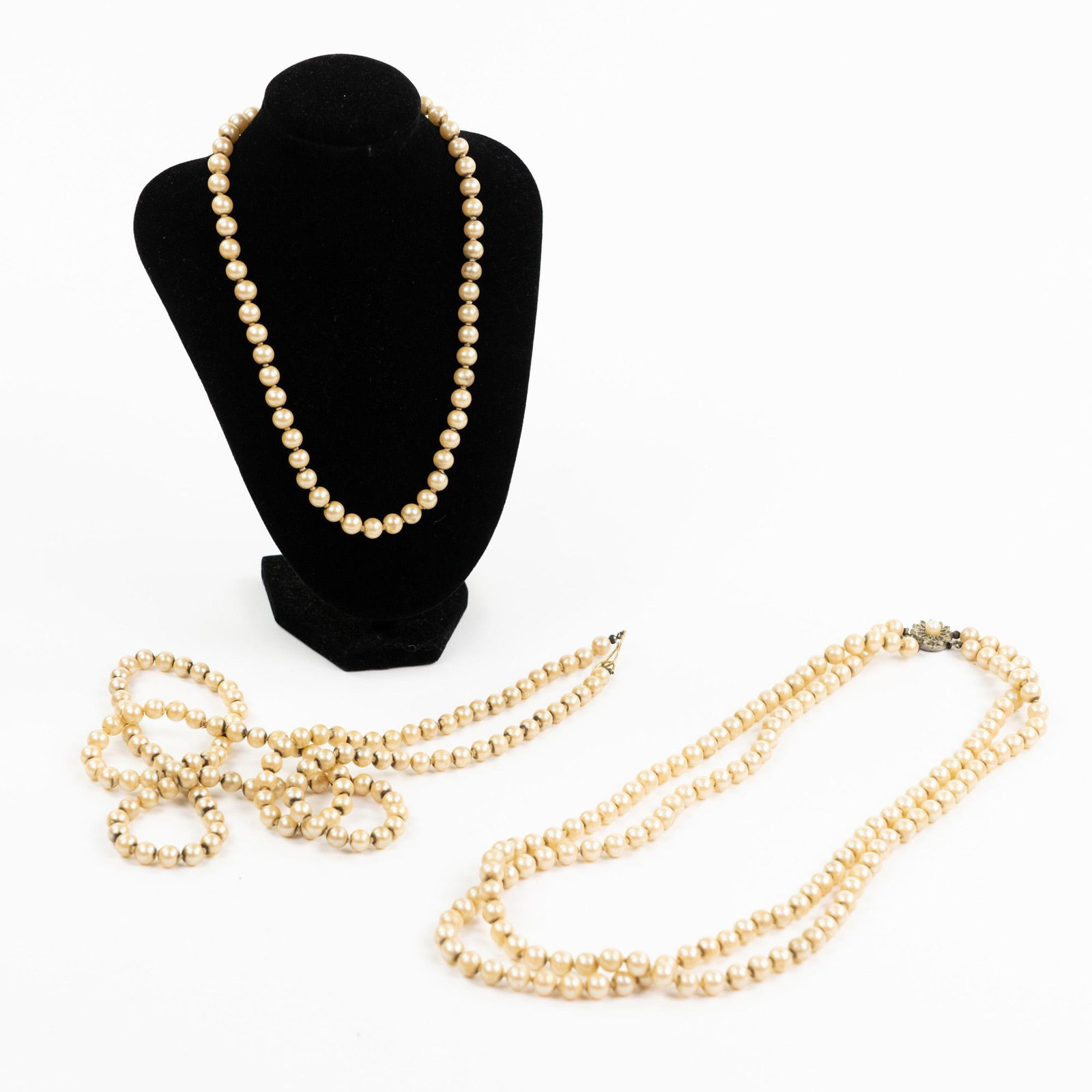 (3) Vintage Faux Pearl Necklaces: A group of three (3) faux pearl necklaces including a multi-strand necklace with clip clasp, a single strand necklace with hook clasp, and a single strand choker with hook clasp. Measurements are for 