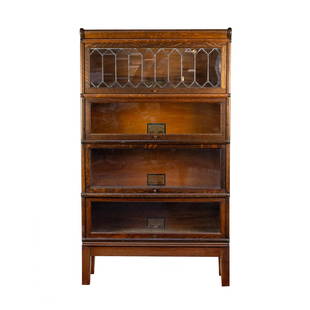 Globe-Wernicke Oak Four Section Barrister Bookcase: A Globe-Wernicke Company four section barrister bookcase each with original label on interior, top drawer having lead glass front with tiger oak veneer and brass accents. SHIPPING Atlanta Auction Gall