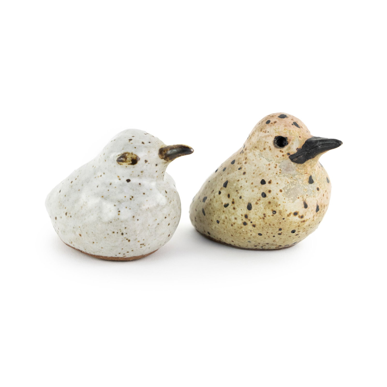 (2) Hand Made Art Pottery Decorative Sanderling Birds: A pair of hand made, salt glazed, hollow art pottery Sanderling birds having painted speckles. One bird incise signed Vera on underside.