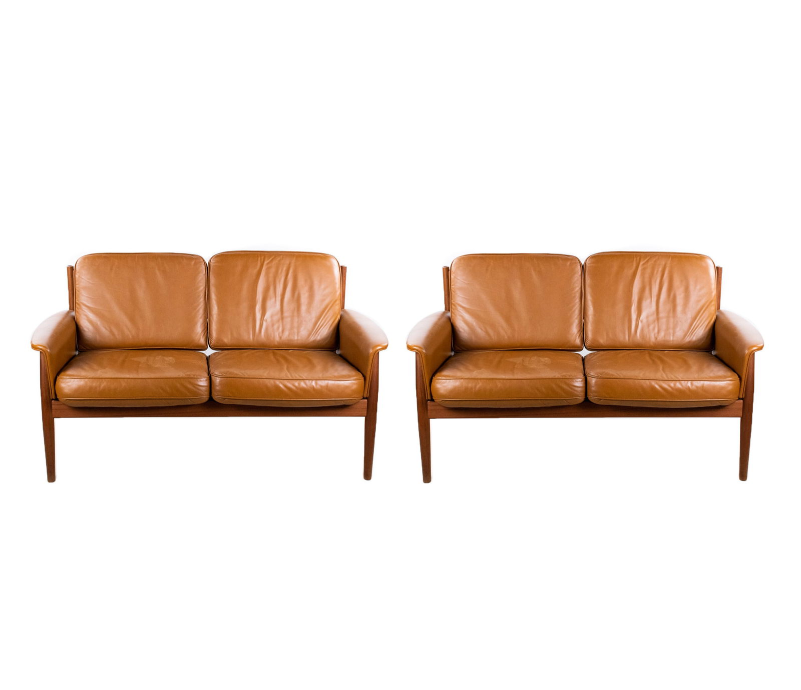 France & Sons Settees by John Stuart for Ff Caffrance: A matching pair of France & Sons saddle tan leather settee sofas by John Stuart for FF Caffrance having teak frames with slatted backs and leather upholstered arm rests; atop four straight tapered leg