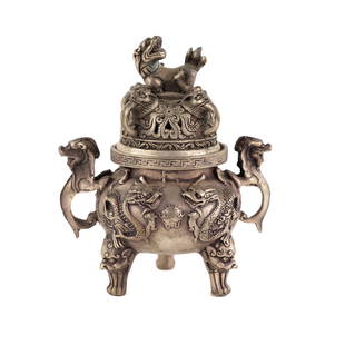 Silver Tibetan Dragon and Lion Incense Burner: A Tibetan silver censer or incense burner having handles and a lid shaped in the form of a guardian lion and featuring dragon and guardian lion motifs throughout. Marked Da Ming Xuande nianzhi.