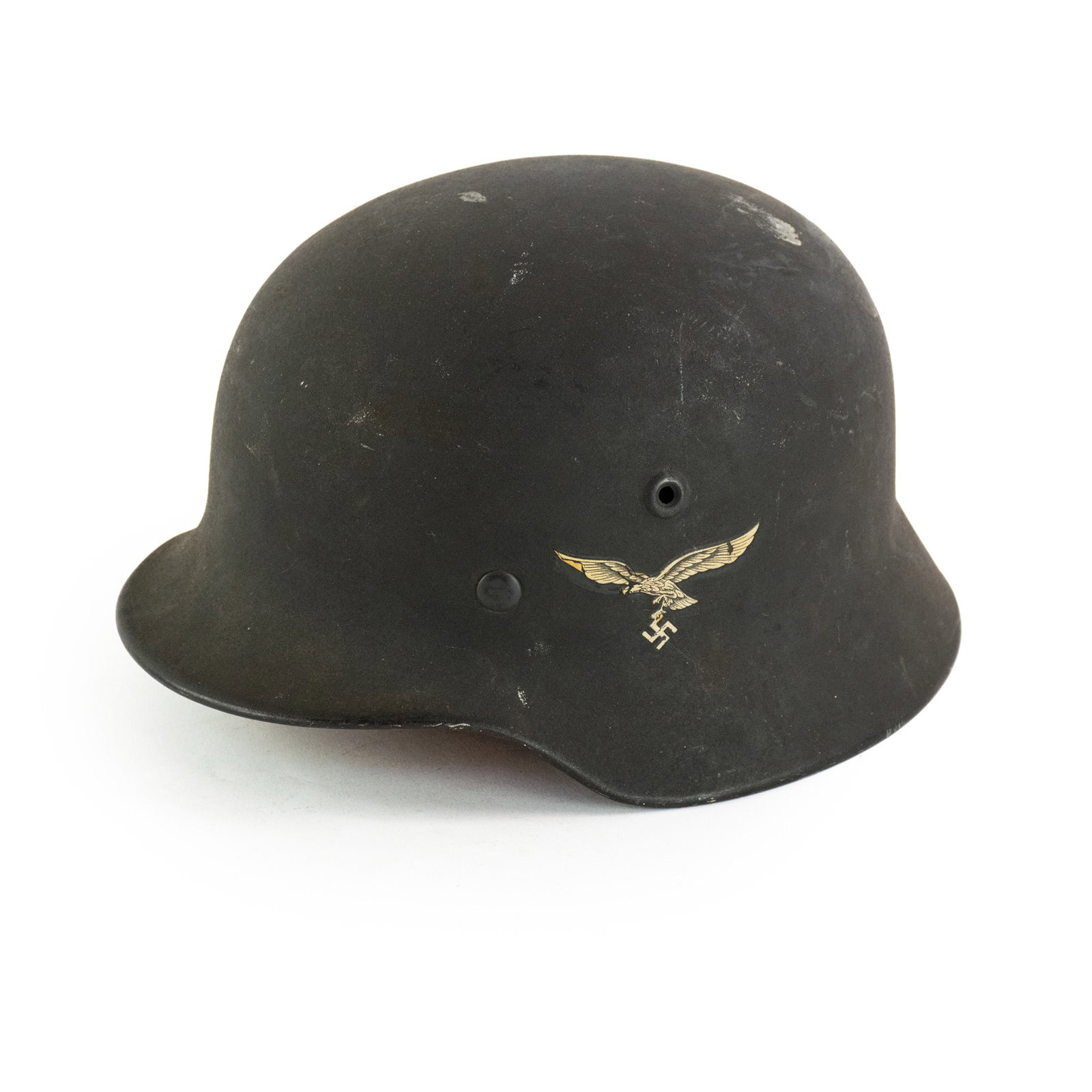 World War II German Luftwaffe M42 Single Decal Helmet: A German World War II M42 helmet manufactured from steel and having an interior leather liner and featuring a single decal of the Luftwaffe depicting an eagle and swastika.